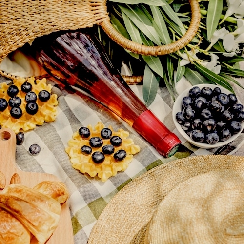 Summer Picnic Blanket With Food And Wine Bottle